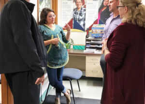 Rena Greene talks to board member Fred E. Parady (left) and AHFC's CFO Mike Strand and Public Housing Director Cathy Stone.