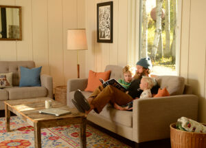 Family sitting on couch enjoying an efficient home