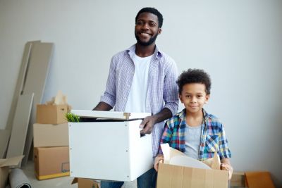 Father And Child Unpacking Boxes After Moving To New Home SBI 324036646   Medium