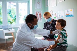Photo of a doctor giving a child a shot.