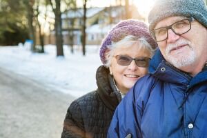 Senior Couple Candid Portrait During A Winter Walk In Suburbs