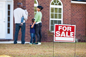 Stock Family Looking At House With For Sale Sign   Blog Post Horizontal