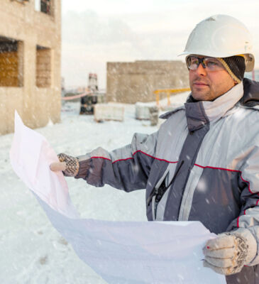 Stock Man Looking At Plans In Cold
