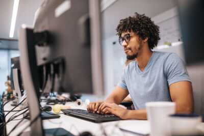 Stock Young Man On Computer